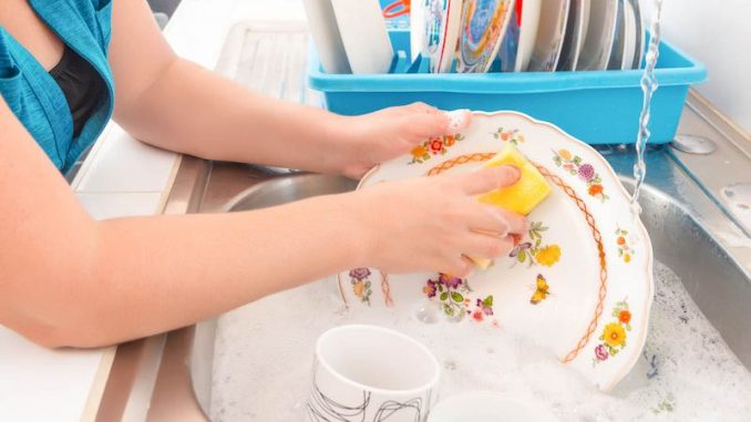 Washing the dishes on the kitchen sink